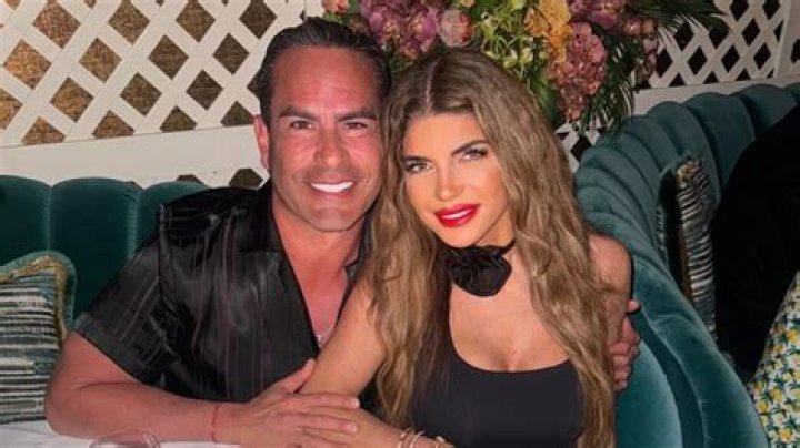 Teresa Giudice and husband Luis Ruelas sitting on a beach bed in Sardinia